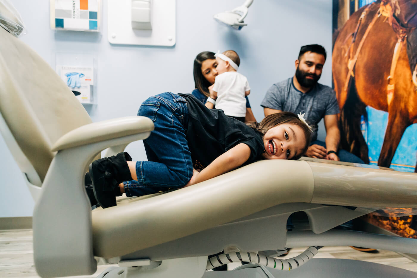A child playing in the dentist chair at the dentist. Sometimes, working with patients can be difficult, and that takes experience to know how to deal with.