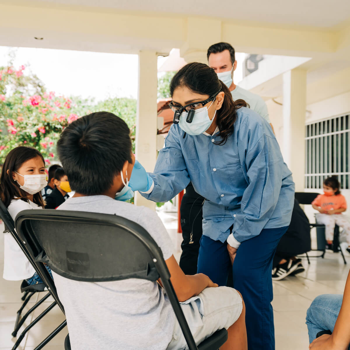 A dentist performs a checkup on a pediatric patient on a humanitarian aid trip to Mexico.