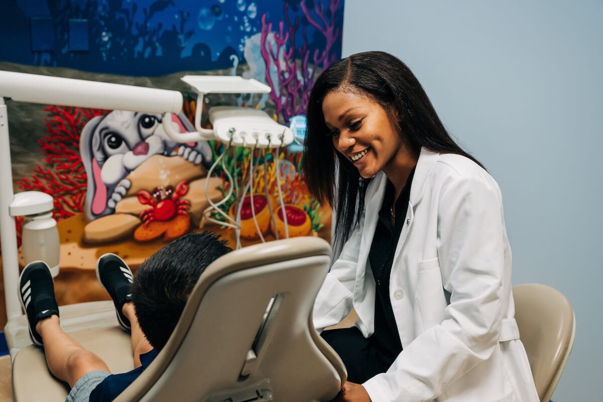 Dental practice ownership was incredibly important for this young dentist, pictured speaking with a pediatric patient.