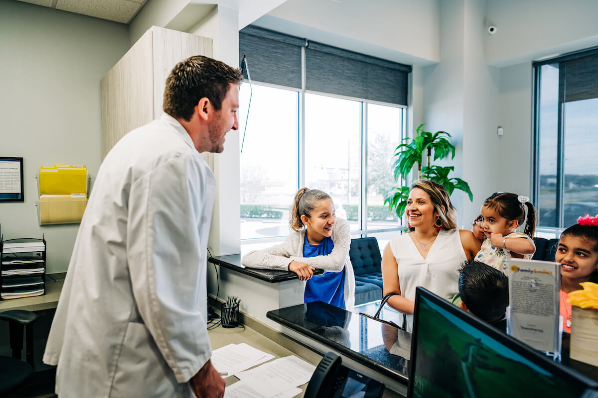 A CDP dentist speaks with a family before they leave the office, helping to foster their relationship and reinforce the importance of healthy habits.