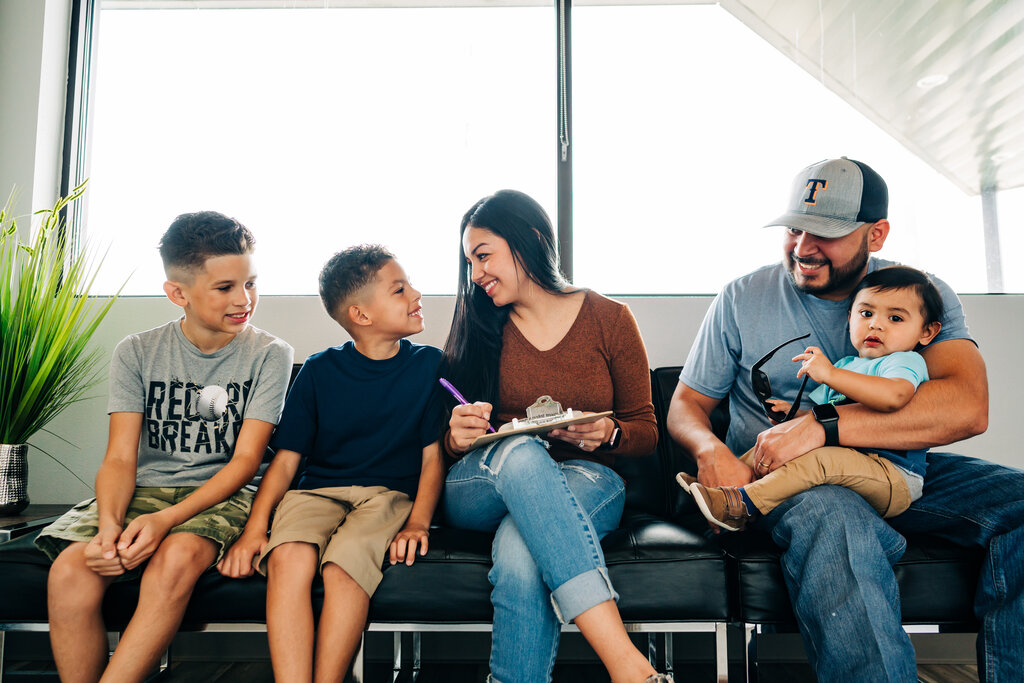 Family in a dentist waiting room.